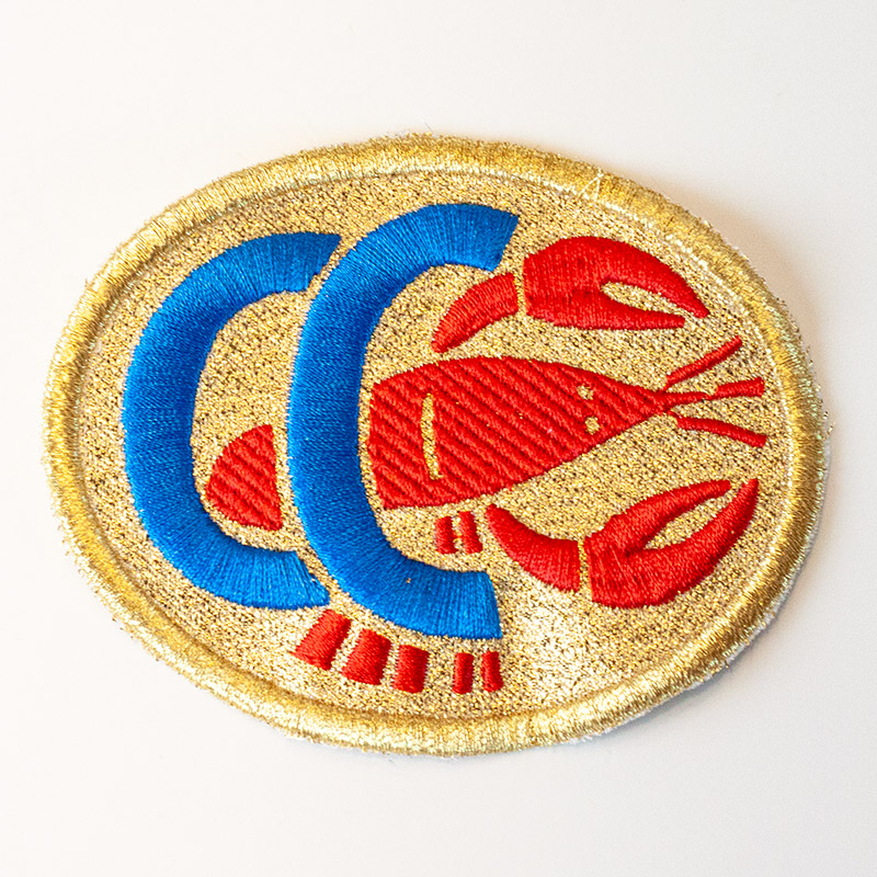 Stoffwappen mit Goldkordel